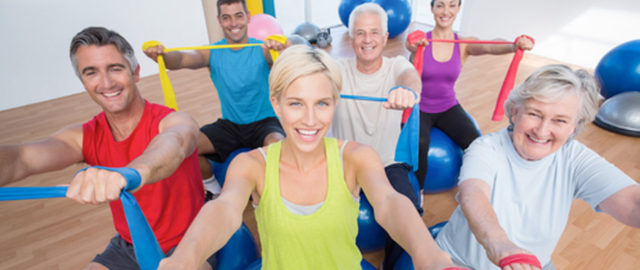 six people smiling while working out