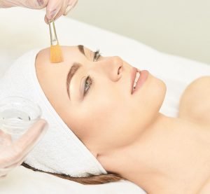 A woman undergoing a facial peel at a San Diego med spa.